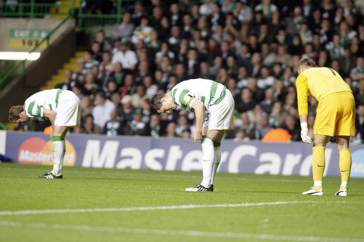Celtic players hang their heads after losing to Arsenal. (Graham Stuart/AFP/Getty Images)