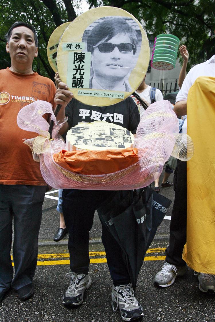 Chen Guangcheng's picture being held by a pro-democracy activist during a protest in Hong Kong. (Mike Clarke/AFP/Getty Images)