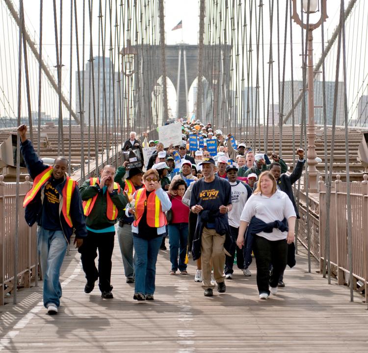 Over a thousand parents, activists, and District Council 1707 union members marched over the Brooklyn Bridge on Wednesday to protest proposed cuts to child care-centers and classrooms in Mayor Michael Bloomberg's budget.  (Aloysio Santos/The Epoch Times)