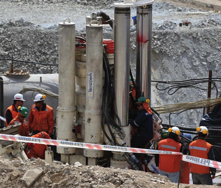 Rescuers drill a new hole with their new Strata 950 excavator at the San Jose mine, Copiapo, Chile, September 2, 2010. The morale of 33 miners trapped in Chile soared Wednesday after music and hot meals were supplied, while NASA advisers praised their 'courage' and provided advice on daylight deprivation, as a rescue drill inched closer. (Martin Mejia/Getty Images)