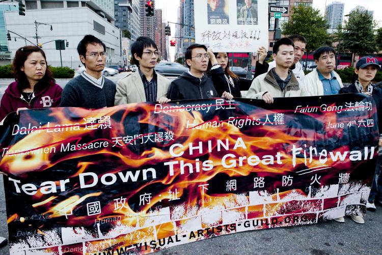 On the anniversary of Chinese Communist Party (CCP) taking control of China, members from various groups promoting change in China held a candlelight vigil in front of the Chinese Consulate in west Manhattan on Tuesday night.  (Henry Lam/The Epoch Times)