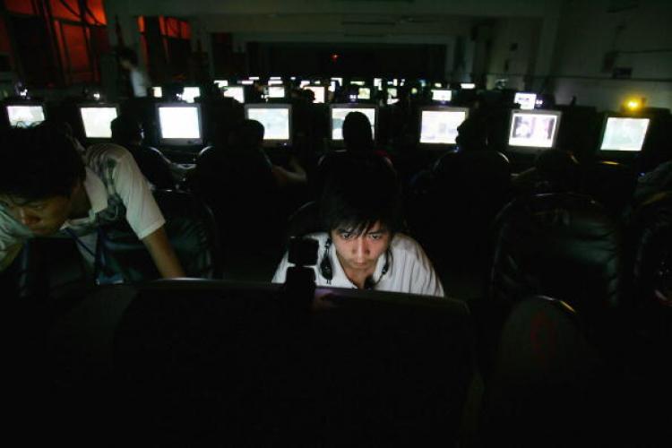 A young man in a cyber cafe in Wuhan, China, sits at work at a computer. The Chinese regime encourages individuals known as 'patriot hackers' to steal information from governments and companies. (Cancun Chu/Getty Images)