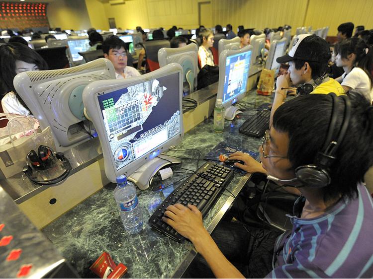 People use computers at an Internet bar in Beijing. (Liu Jin/AFP/Getty Images)