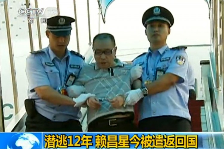This TV grab taken on July 23, 2011 from China's Central Television shows fugitive Chinese businessman Lai Changxing escorted by Chinese authorities after he landed in the Chinese capital aboard a civilian flight in the custody of Canadian police, at the  (STR/AFP/Getty Images)