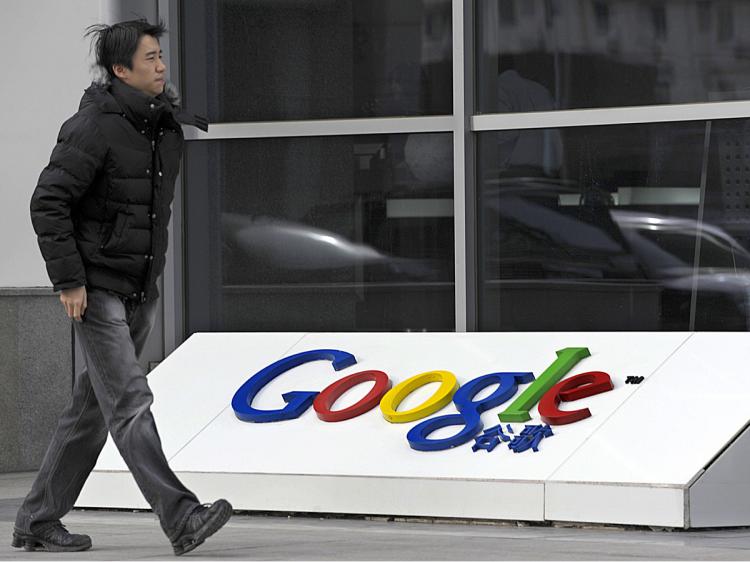 A man walks past the company logo in front of the Google China headquarters building in Beijing. (Liu Jin/AFP/Getty Images)