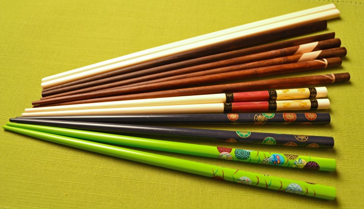 Pictured are a few styles of chopsticks. From front to back, the first three are Chinese-style, tapered and painted bamboo chopsticks; the next three are Japanese-style, stained wood chopsticks (third pair has flat triangular ends); the white pair are made of melamine and are flat and square at top with blunt-tip ends. Although made in China, they are used throughout Asia, especially Vietnam. (Vanessa Rios/The Epoch Times)