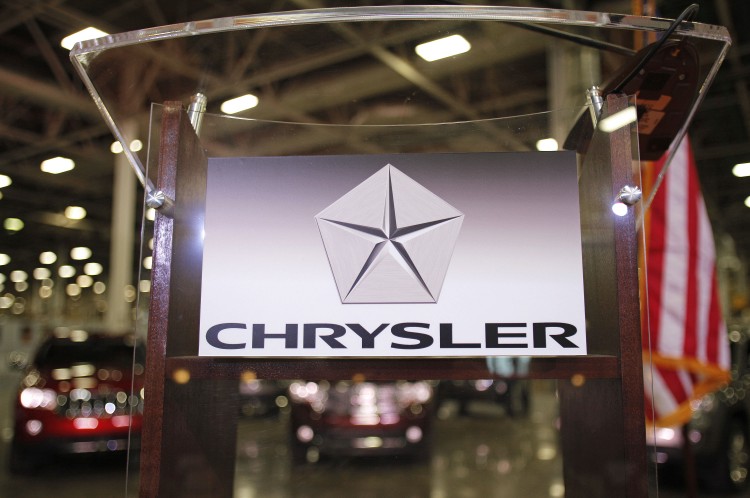 The Chrysler Group logo is attached to a podium at Chrysler's Jefferson North assembly plant at an event last April. Chrysler reported a second-quarter profit of $436 million, driven by robust North American demand. (Bill Pugliano/Getty Images)
