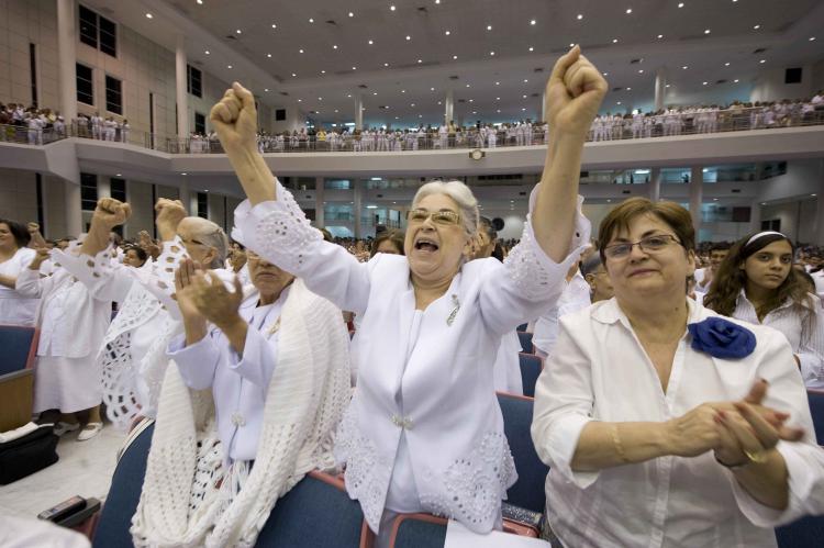 Congregation member Bertha Salva (2L) cheers the speech by Democratic presidential hopeful New York Senator Hillary Rodham Clinton at the Congregation Mita en Aaron Protestant Church in San Juan, Puerto Rico on May 31, 2008.  (Robyn Beck/AFP/Getty Images)