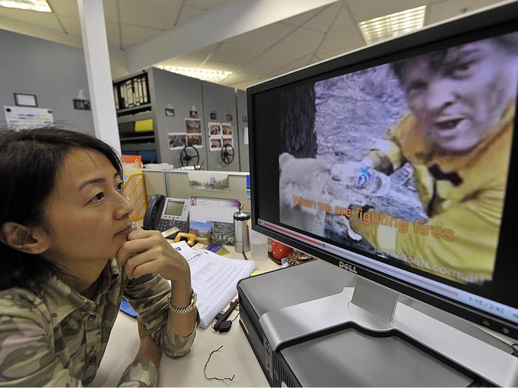 A woman watches a YouTube video in Hong Kong. Chinese YouTube clones will be heavily regulated by the regime. (Mike Clarke/AFP/Getty Images)