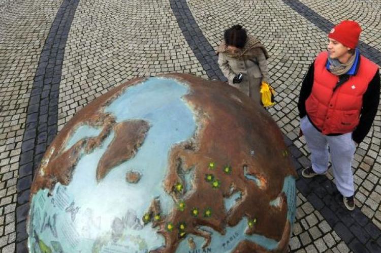 People stop to look at a globe part of an art installation entitled 'Cool Globes', an exhibition about combating global warming and climate change in Kongens Nytorv in Copenhagen on December 8, 2009. (Adrian Dennis/AFP/Getty Images)