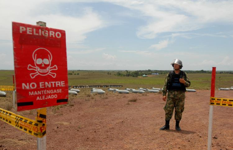 A Colombian Army bomb disposal expert gets ready to start the controlled detonation of Chilean-made CB-250K cluster bombs May 7, 2009 at the Marandua military base, Vichada department, Colombia (LUIS RAMIREZ/AFP/Getty Images)