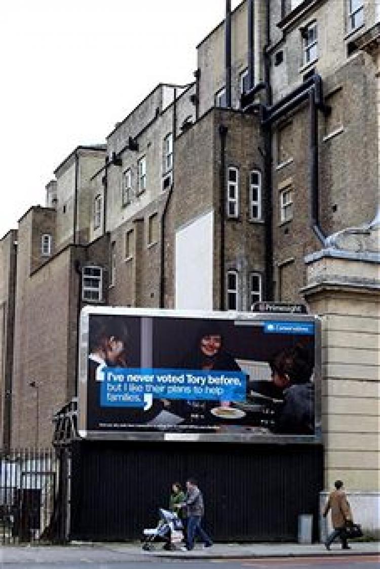 A family walk past one of the Conservative party's new nationwide poster campaigns on February 15, 2010 in London (Dan Kitwood/Getty Images)