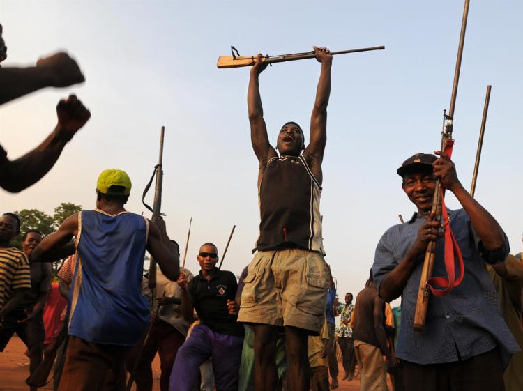 Fighters of a local self-defence force sing with riffles on February 18, 2009 in Bangadi, north eastern Congo. (Lionel Healing/AFP/Getty Images)