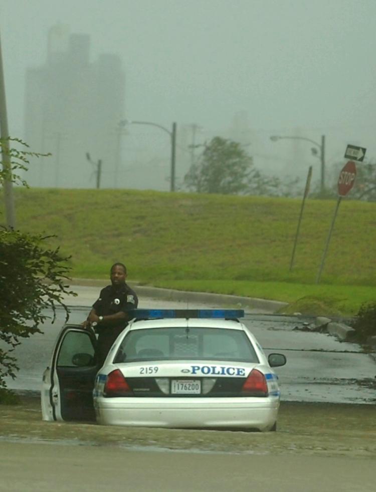 A police officer waits for assistance after his car stalled in flood waters in New Orleans, Louisiana.   (Stephen Morton/Getty Images)
