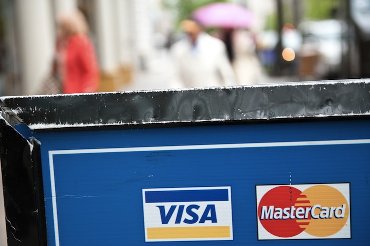 Visa and MasterCard credit card logos are seen on a sign in Washington on March 30, 2012. (Nicholas Kamm/AFP/Getty Images) 