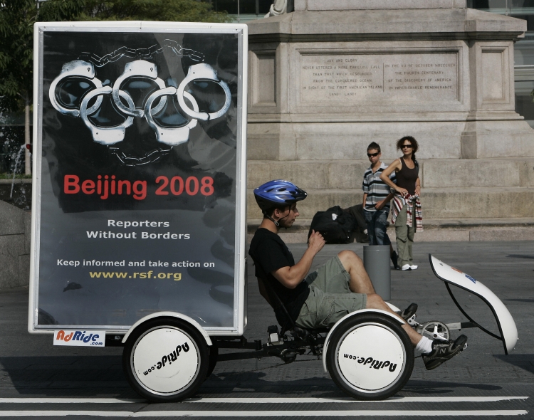 Bikers with mobile billboards from the Reporters Without Borders group launch an international campaign in New York 07 August 2007 on the 2008 Summer Olympic Games in Beijing. In the run-up to Olympics, the Communist Regime has tightened its grip on oppre (Timothy A. Clary/AFP/Getty Images)