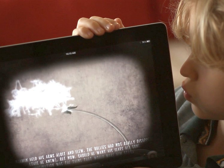 A young boy blows the dandelion in the Dandelion app. (Courtesy of Galvin Scott Davis) 