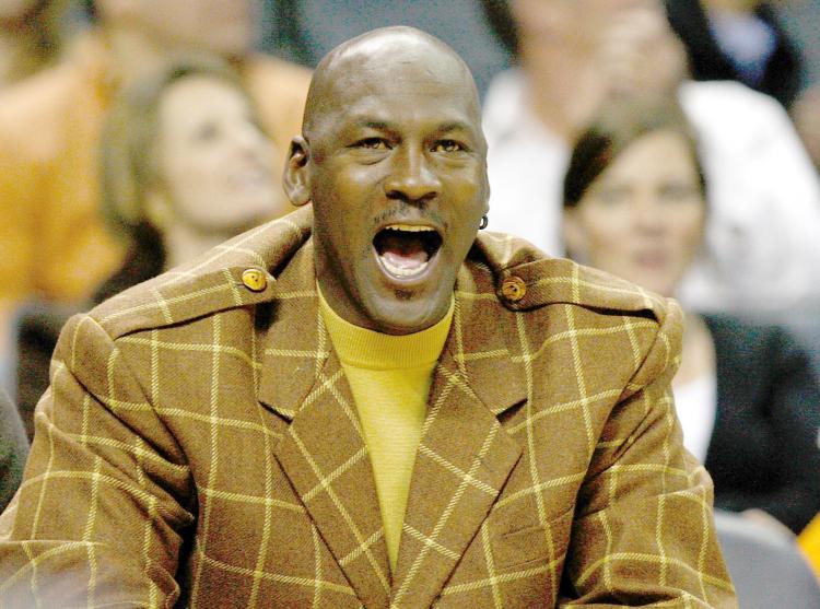 Michael Jordan, managing partner of the Charlotte Bobcats, reacts to a play against the Orlando Magic during their game at Time Warner Cable Arena on February 20, in Charlotte, North Carolina. Jordan announced David Thompson as his host for (Streeter Lecka/Getty Images)