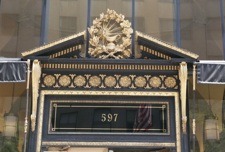 The pediment above the front door is decorated with the Scribner's Sons publishing logo of a burning oil lamp. (Tim McDevitt/The Epoch Times)