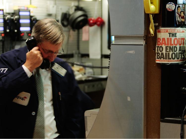 A financial professional uses a telephone on the floor of the New York Stock Exchange near the end of the day's trading January 7, 2009 in New York City.    (Chris Hondros/Getty Images)