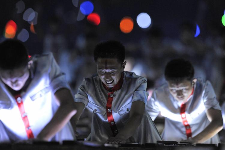 During the opening ceremony of the Beijing Olympics, the drummers wore costumes that looked like it was stained with a streak of blood. Some pointed out that the drummers looked like they were split in two. (Jewel Samad/AFP/Getty Images)