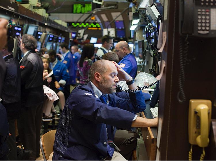 Traders work the floor at the New York Stock Exchange on November 27, 2009 in New York City. U.S. markets dropped on Friday, reacting to global worries over Dubai's debt problems. (Michael Nagle/Getty Images)