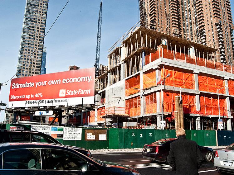 STIMULUS PLAN: The construction site of the new Signature Center at 10th Avenue and 42nd Street. A billboard in front reads 'Stimulate your own economy.'  (Joshua Philipp/The Epoch Times)
