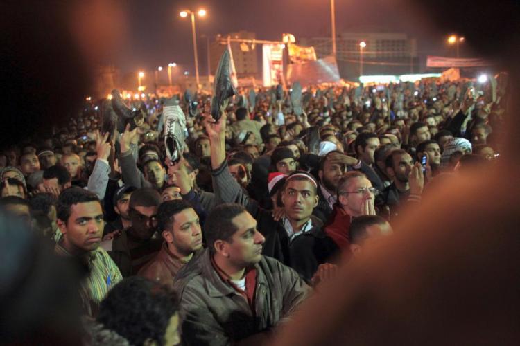 Anti-government protesters watch in Tahrir Square as President Hosni Mubarak speaks to the nation on February 10, 2011 in Cairo, Egypt. (John Moore/Getty Images)