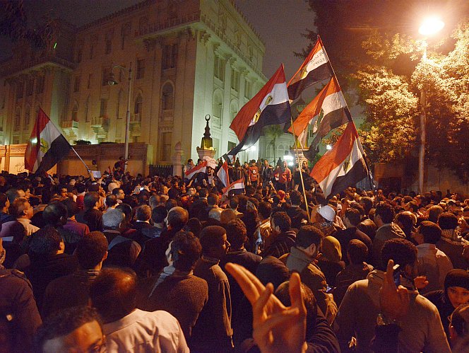 Egyptian protesters gather outside of the presidential palace in Cairo on Dec. 4. While American media coverage of Arab Spring protests was thorough, Egyptian activists say the truth of widespread protest and violence under President Morsi is barely acknowledged. (Gianluigi Guercia/AFP/Getty Images)