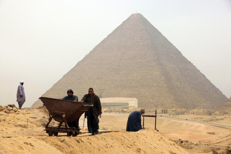 Workers dig at an excavation site in front of the Giza pyramids on January 11, 2010. A team of Egyptian archeologists has rediscovered the ancient tomb belonging to Ptahmes, the mayor of Memphis.  (Victoria Hazou/Getty Images)