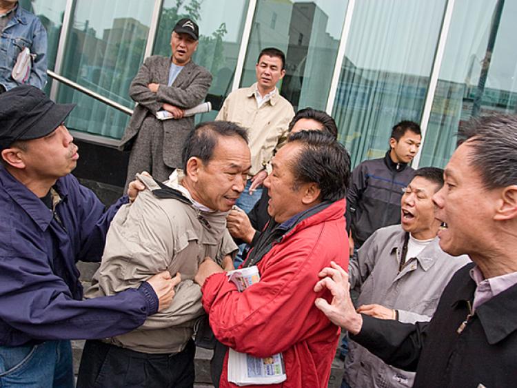 Flushing resident Edmond Erh was assaulted by a pro-CCP mob while supporting a booth for quitting the Chinese Communist Party.  (Dayin Chen/The Epoch Times)