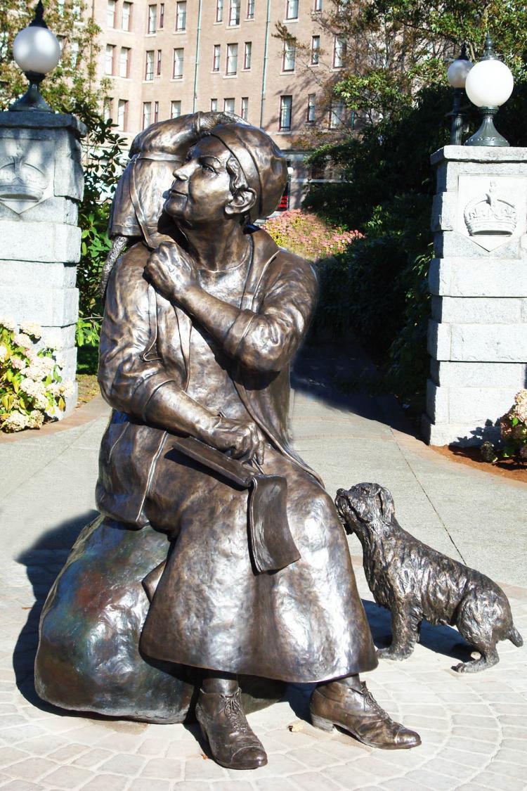 The bronze sculpture unveiled Wednesday of Emily Carr with her beloved dog Billie and her pet monkey, Woo. (Sandra Shields/The Epoch Times)