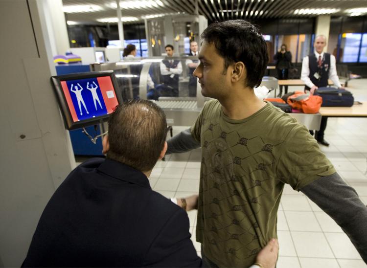 A passenger undergoes a security scan at Schiphol Airport in Amsterdam, on Dec. 28, 2009. The EU announced that new screening technology could allow certain liquids to safely pass security. (Ed Oudenaarden/AFP/Getty Images)