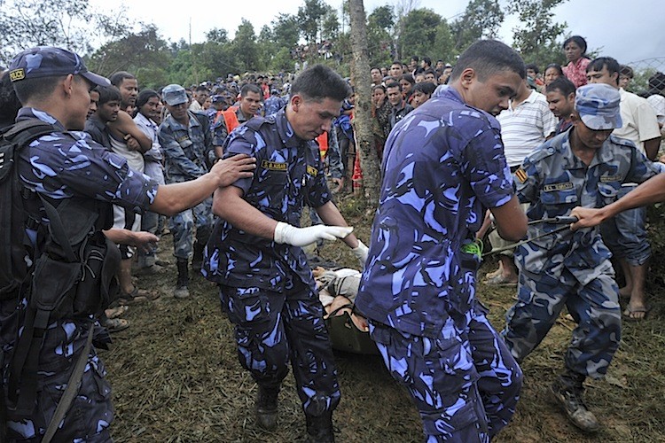 Nepalese police recover the body of a passenger who died when a Buddha Air Beechcraft 1900D aircraft crashed at Kot Danda in Lalitpur, on the outskirts of Kathmandu, on September 25. (Prakesh Mathema/AFP/Getty Images)