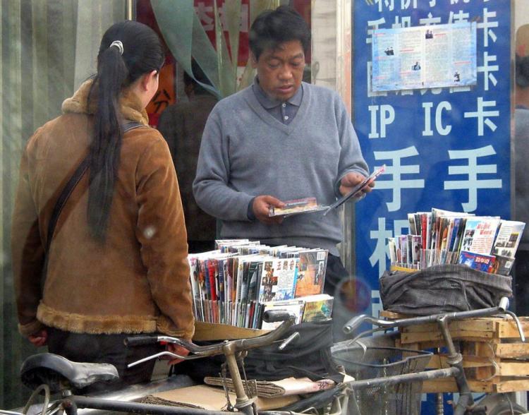 Chinese vendors sell pirated DVD copies of various popular movies, outside a shop in Beijing. The U.S. has reportedly won a WTO case against China involving movie import quotas. (Goh Chai Hin/AFP/Getty Images)