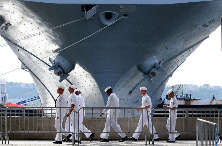 FLEET WEEK: U.S. Navy sailors walk past the USS Iwo Jima docked on the Hudson River during Fleet Week May 22, 2009 in New York City.  (Mario Tama/Getty Images)