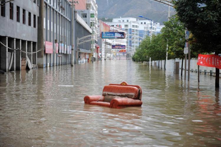 An old couch floods down a street after the massive landslide in Zhouqu, northwest China's Gansu province on August 12, 2010. (STR/AFP/Getty Images)