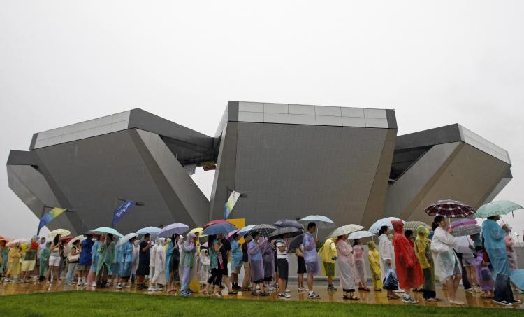 Spectators queue to get food at the centre court of the Olympic Green Tennis Centre in Beijing.   (Behrouz Mehri/AFP/Getty Images)