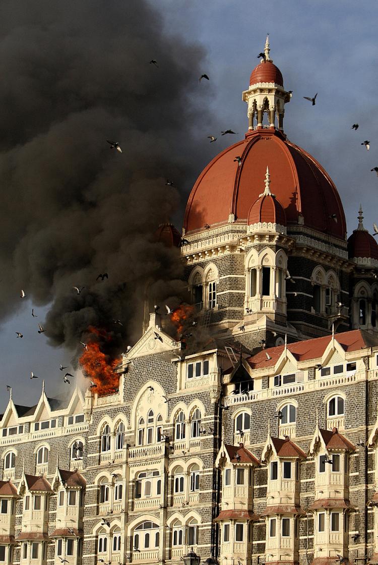 Flames gush out of the roof of The Taj Mahal Hotel in Mumbai on November 27, 2008, one of the sites of attacks by alleged militant gunmen.    (Indranil Mukherjee/AFP/Getty Images)