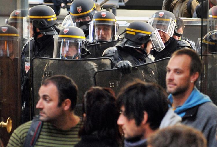 Anti-riot policemen contain some 800 on strike rail workers gathered at Bordeaux's Saint-Jean station on Oct. 22, 2010 to protest against the government's bid to hike the retirement age from 60 to 62. (Pierre Andrieu/AFP/Getty Images)