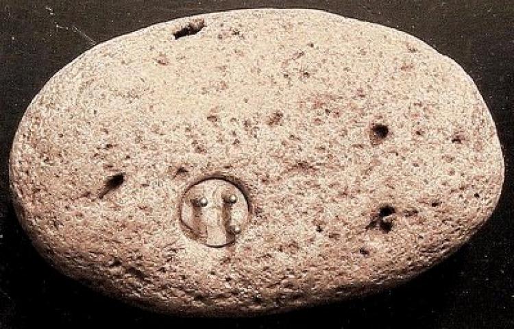 A stone embedded with a three-pronged plug could be either evidence for a technologically advanced ancient civilization or a hoax.  (Courtesy of John J. Williams)