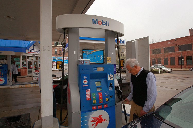 A motorist fuels his car at a Mobil station in Chicago