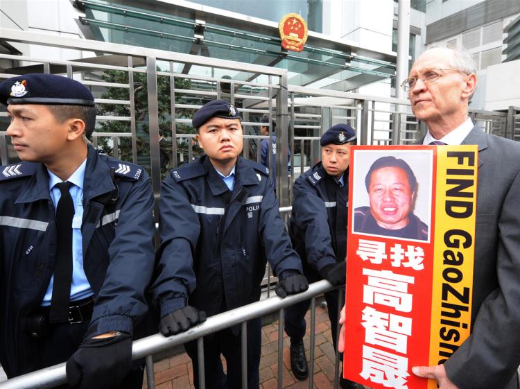 Solicitor John Clancey (R), a member of a lawyers concern group protests for the release of Beijing human rights lawyer Gao Zhisheng outside the China Liaison office in Hong Kong on February 4, 2010. Gao was taken from his home on February 4, 2009 and his whereabouts are still unkown. (Mike Clarke/AFP/Getty Images)