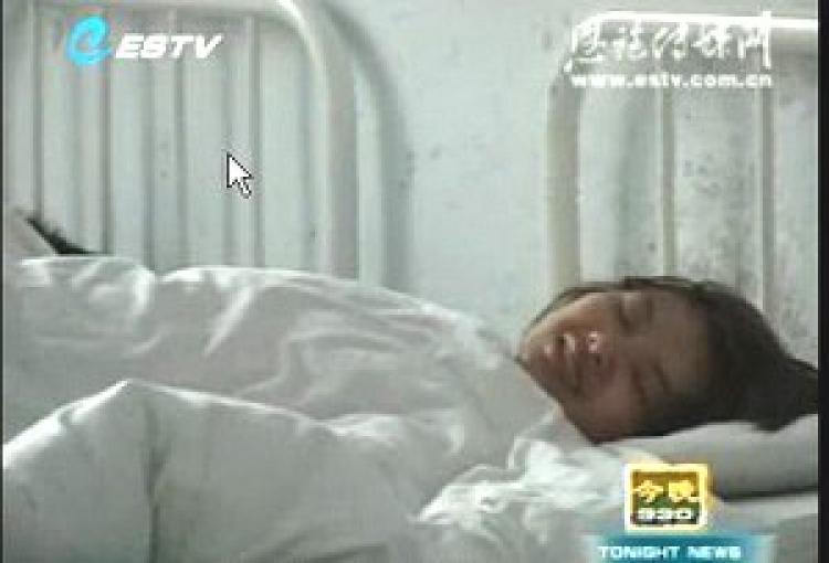 Deng Yujiao, when she was locked in a psychiatric hospital. (Screen grab from Enshi City TV/The Epoch Times)