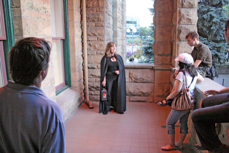 Calgary Ghost Tours Owner/Operator Johanna Lane describes the story of a politician shot in a card game in the basement of Old City Hall who reportedly now haunts the site. (The Epoch Times)