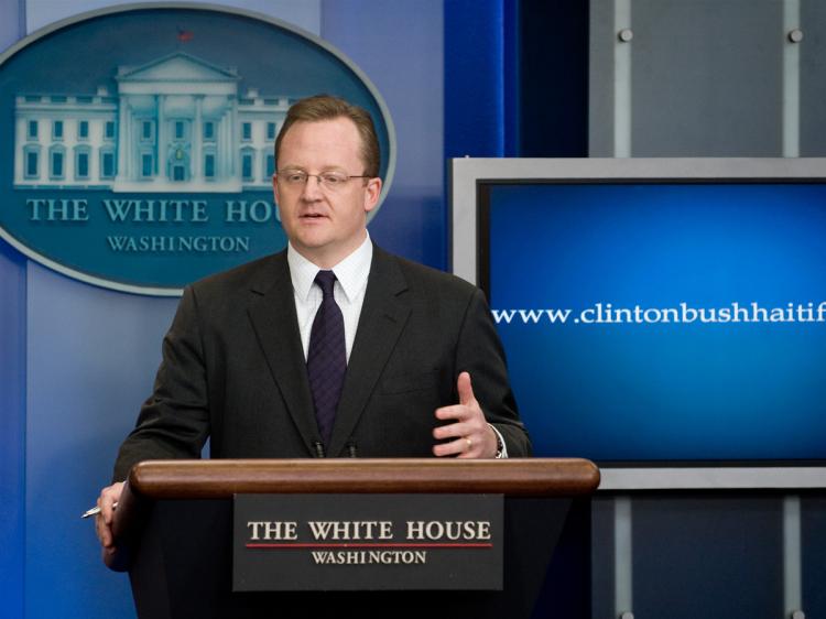 White House Press Secretary Robert Gibbs speaks alongside a monitor displaying the website address for information about donating to the Clinton Bush Haiti Fund in Washington, DC, on January 15, 2010. (Saul Loeb/AFP/Getty Images)