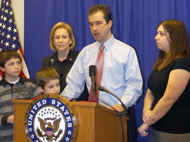 TAXED: John Lavelle (2nd R) tells of the financial hardship of his family. He is joined by his wife, Amy (R), and sons, Jacob (L) and Zachary (2nd L). The family's hardship has been exacerbated by rising property taxes, a problem Sen. Kirsten Gillibrand (C) hopes to remedy. (Tara MacIsaac/The Epoch Times)