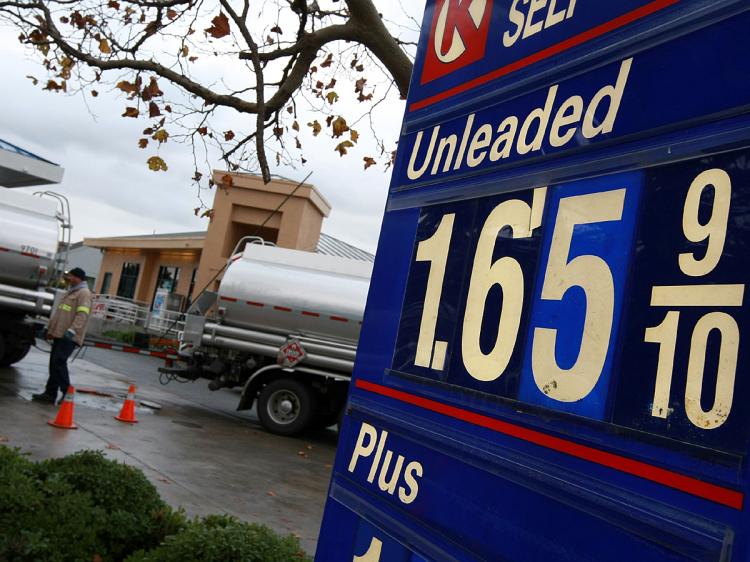 A gasoline truck driver pumps fuel into underground tanks at a Circle K gas station December 16, 2008 in San Rafael, California.    (Justin Sullivan/Getty Images)
