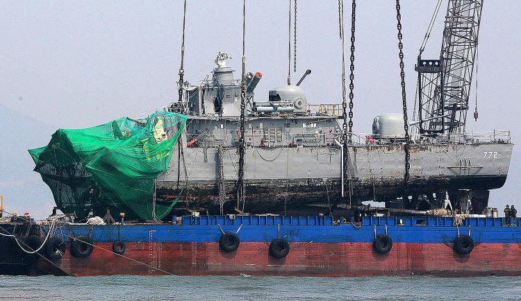 Sunken South Korean warship PCC-772 Cheonan is placed on a barge after being raised by a giant crane, April 15, 2010. South Korea's military believes a North Korean submarine torpedoed a South Korean warship in March, the Yonhap news agency said. (Byun Yeong-Wook/AFP/Getty Images)