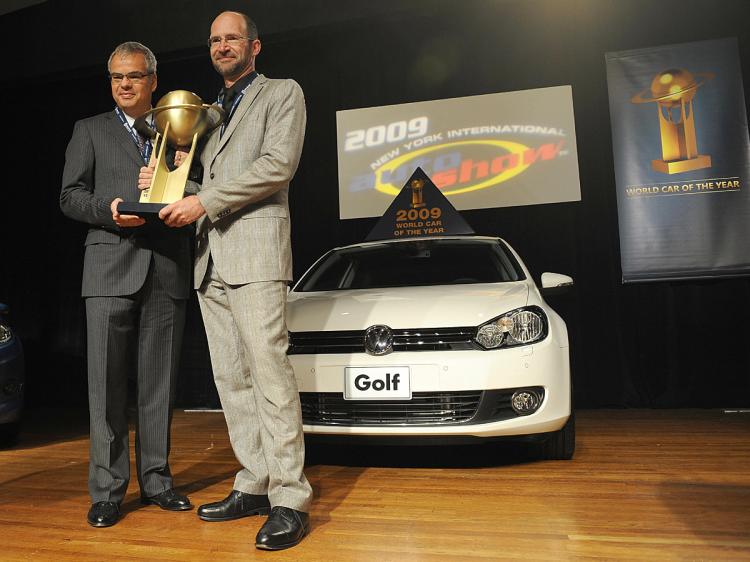 Volkswagen America President Stephen Jacoby (L) and Klaus Bischoff, Dorector Volkswagen Design, hold the trophy a they pose with the Volkswagen Golf, Named the 2009 World Car of the Year at the New York International Auto Show.  (Stan Honda/AFP/Getty Images)